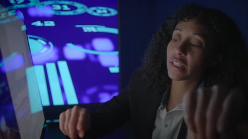 A Business Professional is Engaged in Analyzing Data Insights While in a Dark Environment