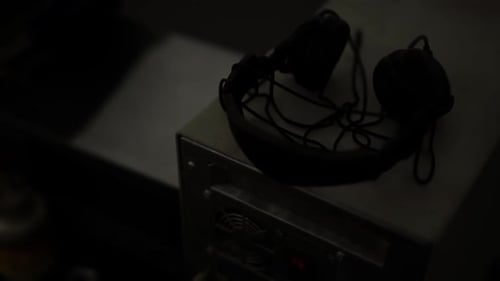 Vintage Headset on a Desk in a Dim Room Creating Nostalgia