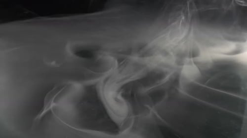 Billowing Gray Smoke on a Dark Background