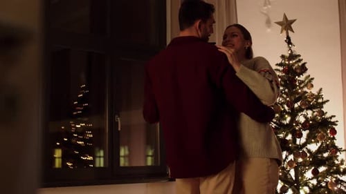 Winter Holidays and People Concept - Happy Couple Dancing Near Christmas Tree