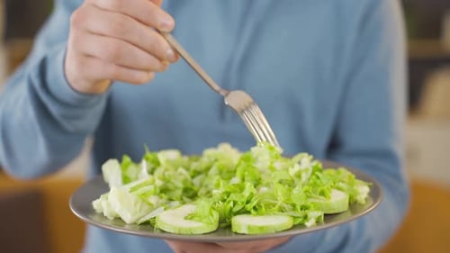 Diet, man eating green salad.