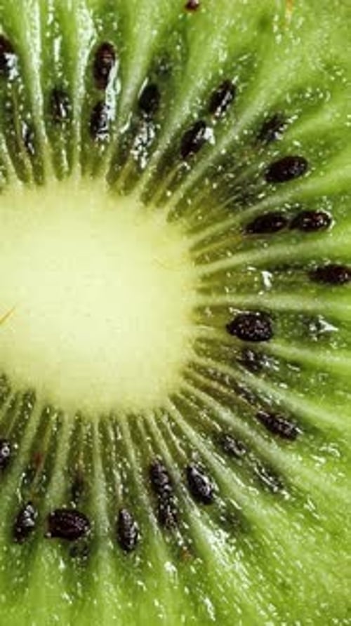 A Lot of Sliced Kiwi Rotating Ripe Tropical Fruits Closeup Vertical