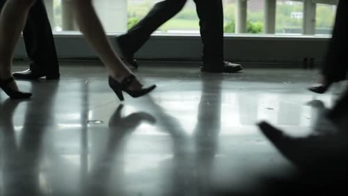 Legs Walking Fast in Business Building Lobby