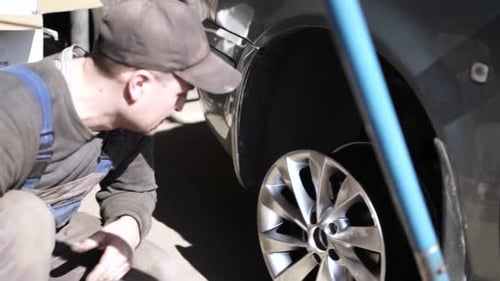 Car wheel service. Mechanic changing tires and rims, balancing the wheels