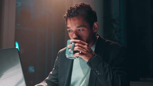 Night, coffee and businessman on laptop for programming, software project or web design in office