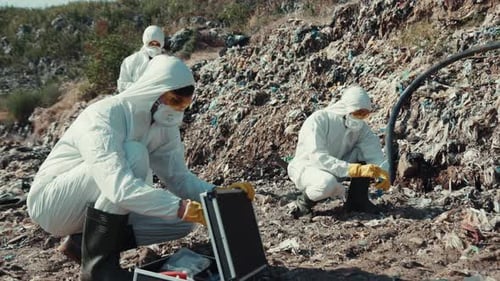 Environmental Scientists Engaged in Field Research While Wearing Protective Gear and Equipment