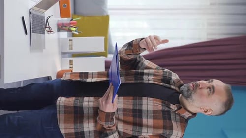 Vertical Video of Freelance businessman in his home office.