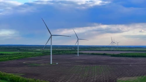 Wind Turbines On A Sunny Summer Day In The Fields
