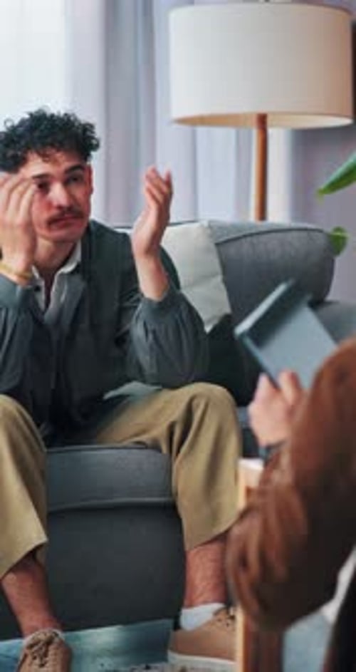 Therapist, counseling or man with stress in office, support or discussion for mental health