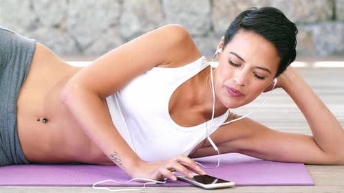 Woman Listening to Music on Yoga Mat
