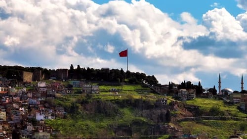 Turkish Cityscape with Flag on Hillside during Daytime
