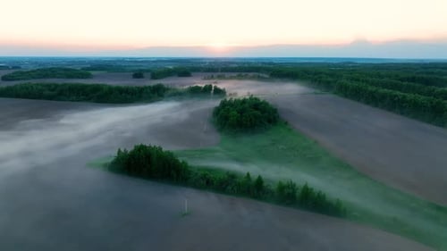 Aerial panoramic view of a foggy rural village at sunrise