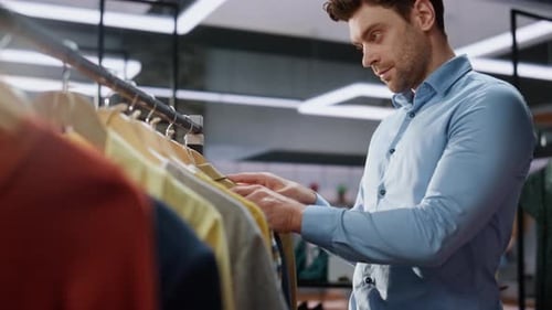 Store Worker Looking Clothes at Boutique Closeup Man Posing Camera Portrait