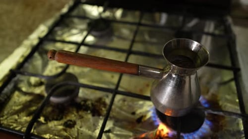 Closeup Footage of Preparation of Turkish Coffee at Gas Stove in Metal Cezve