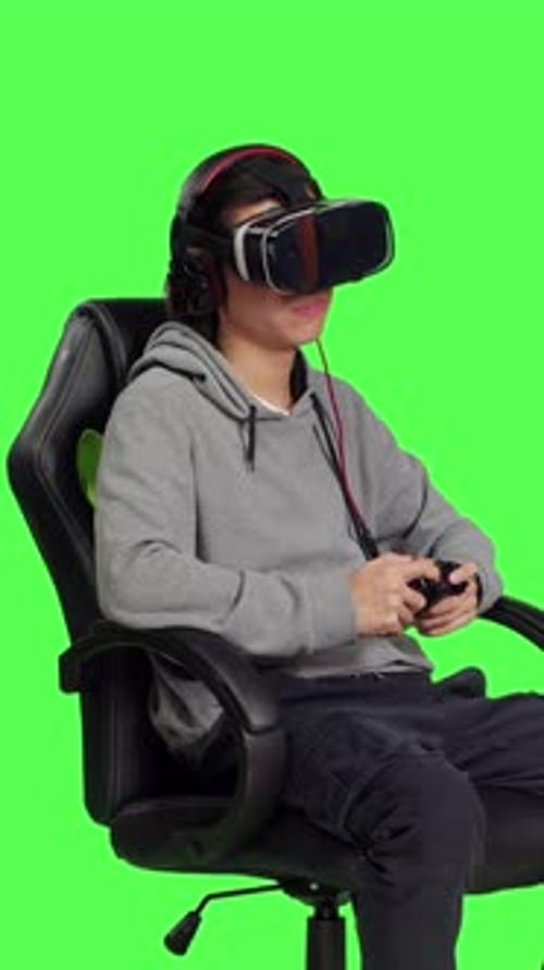 Side View of Asian Guy Plays Mobile Game with Vr