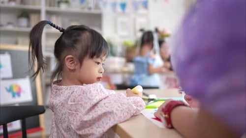 Little Girl Doing Arts and Crafts in Class