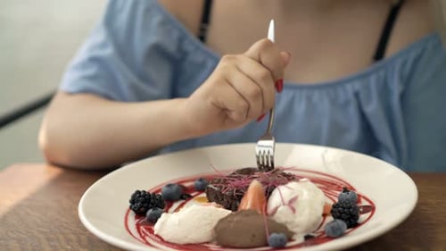 Teenage Girl Eating Dessert in Cafe 20s
