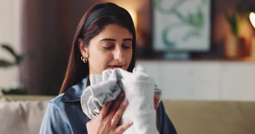 Smell, cleaning and clothes with woman on sofa for laundry, maintenance and fresh linen