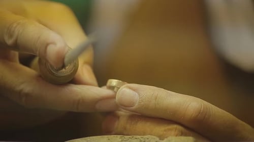 Italian Goldsmith at work building an engagement or a wedding ring.
