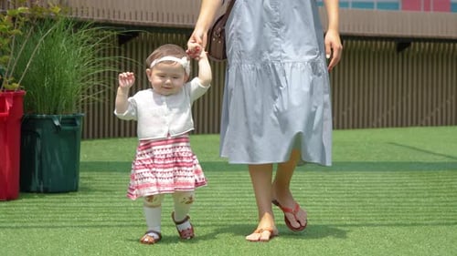 Adorable One-year-old Baby Girl Learn to Walk with Her Mother, Little Baby Study Walking Holding Mot