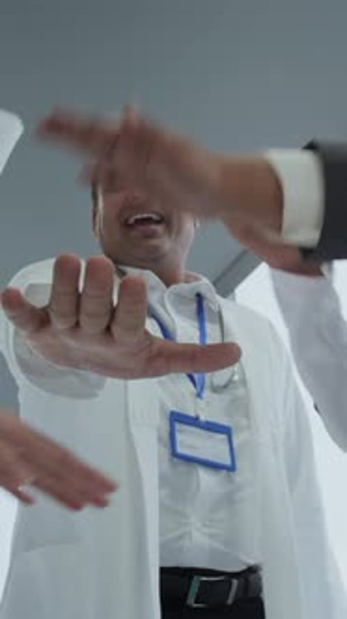 Vertical of Doctors Celebrating Success at Clinic