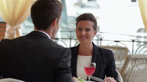 Young Colleagues Enjoying a Lively Business Lunch at a Stylish Restaurant