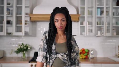 Young Adult Woman in Bright Kitchen With Vegetables