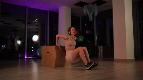 Athletic Woman Performing Triceps Dips in Gym