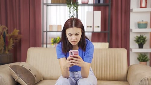 Auburn-Haired Woman Reacts Negatively to Phone News