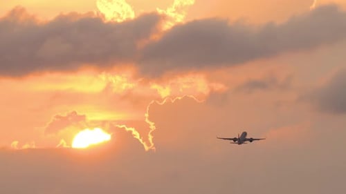 Airplane Flying into the Sunset Sky