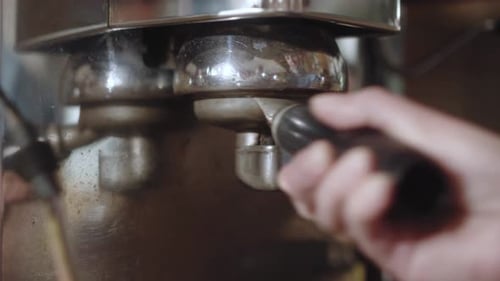 Coffee Making in a Coffee Machine at the Coffee Shop Coffeehouse Once Tempered Holder is Inserted