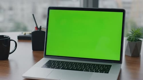 Modern Green Screen Laptop Standing on Office Wooden Desk Close Up. View