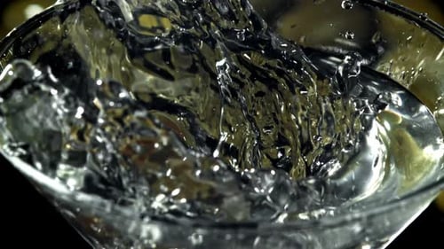 Olives Dropped into Martini Glass Creates Splash