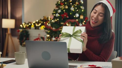 Woman Video Chatting with Gift in Christmas Setting