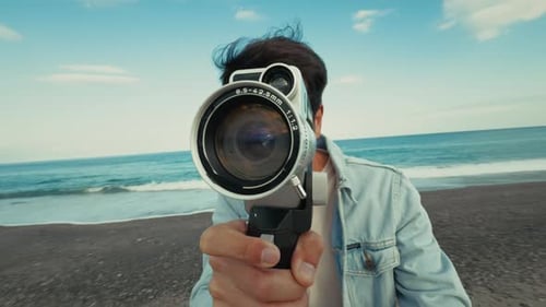 Man With A Vintage Film Camera And Using The Old Lens At The Sea