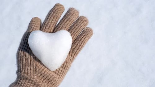 Heart of Snow held in a Gloved Hand