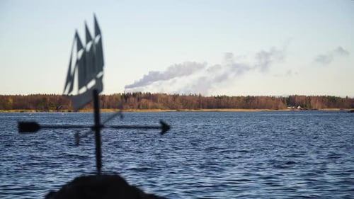 A Weather Vane With The Olkiluoto Nuclear Power Plant In The Background In Rauma, Finland On A Sunny