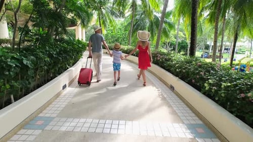 Happy Family Arriving at Tropical Resort on Vacation