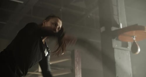 Strong Athletic Woman Training with Battle Rope in Gymnasium