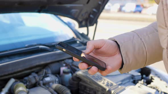 A Driver Frantically Making a Call for Assistance on His Mobile Phone ...