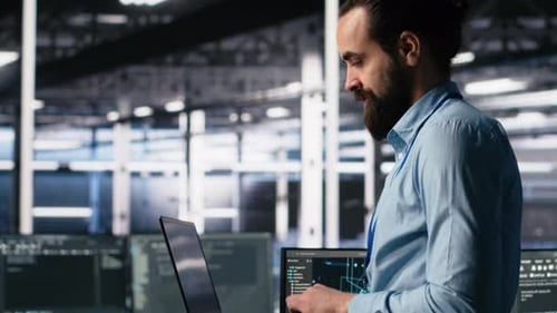 Close Up of Developer in Data Center Coding with Generative AI on Laptop