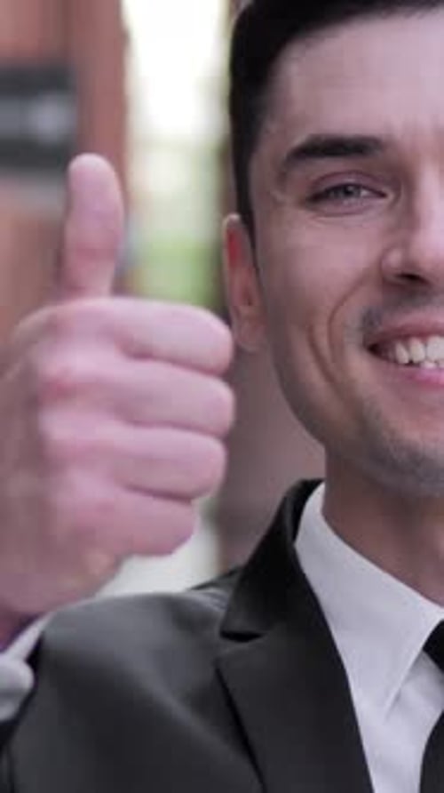 Man in Suit Gives Thumbs Up Approval