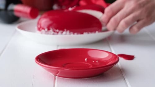 Delicious Red Glazed Cake Being Sliced