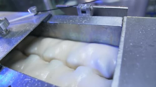Milky creamy substance being rotated in the metal tank.
