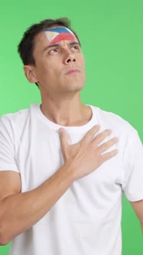 Man Listening to the Philippines National Anthem with Solemnity