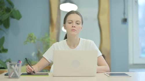 Young Woman Works With Graphics Tablet and Laptop