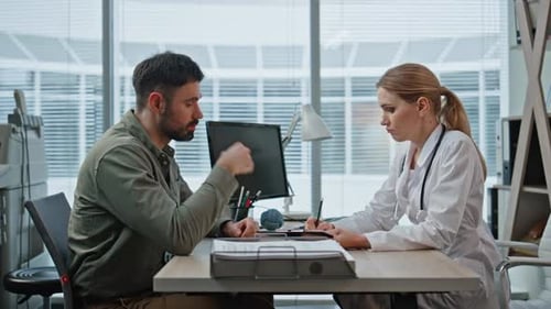Doctor Providing Medical Advice to Clinic Patient Therapist Discuss Treatment