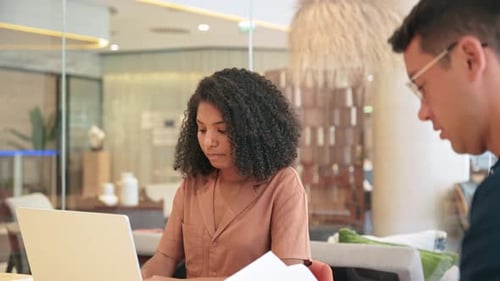 African American Female Bank Manager Consulting Male Client at Meeting