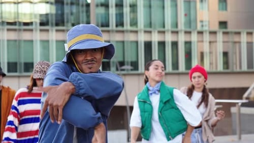 Energetic Young Adults Dancing Together in City Street