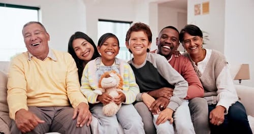 Multigenerational Family Smiling and Laughing on Sofa